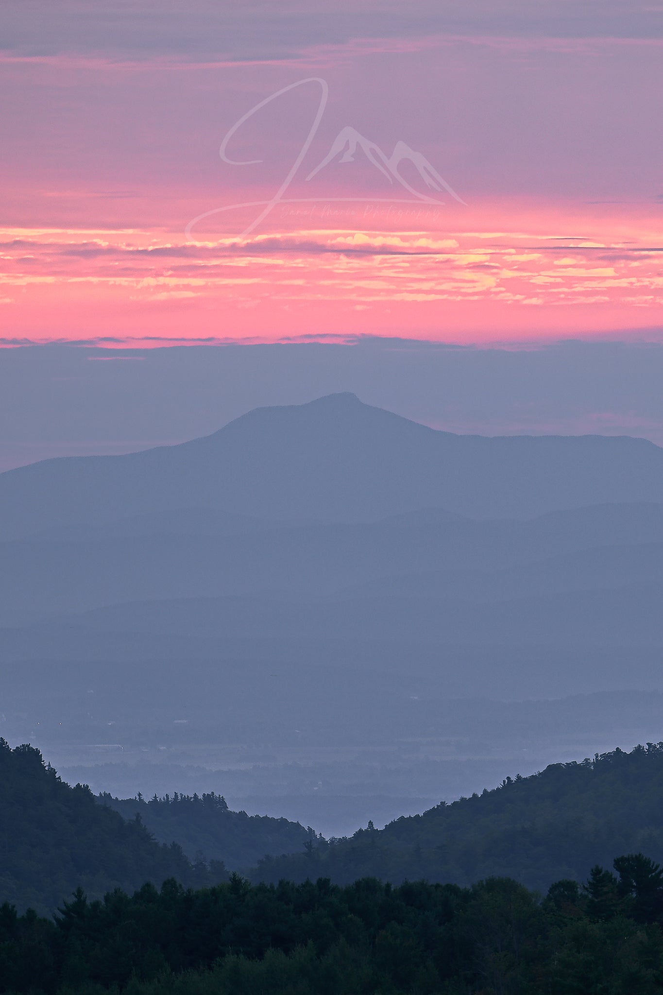 print of a hazy sunrise over the Champlain valley and camels hump mountain from the Adirondack Mountains