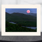 full moon over the Adirondack mountains