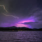 Nature's Dual Dance - Lightning and Aurora in the night sky over Mirror Lake in Lake Placid, New York.