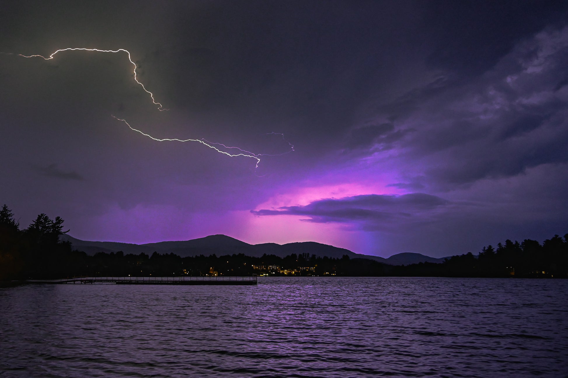 Nature's Dual Dance - Lightning and Aurora in the night sky over Mirror Lake in Lake Placid, New York.